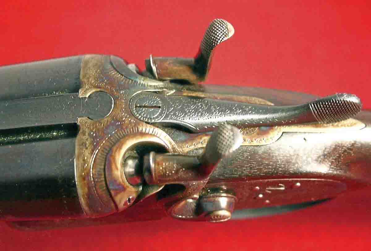 The top of the breech showing the doll’s head fastener and engraving.
